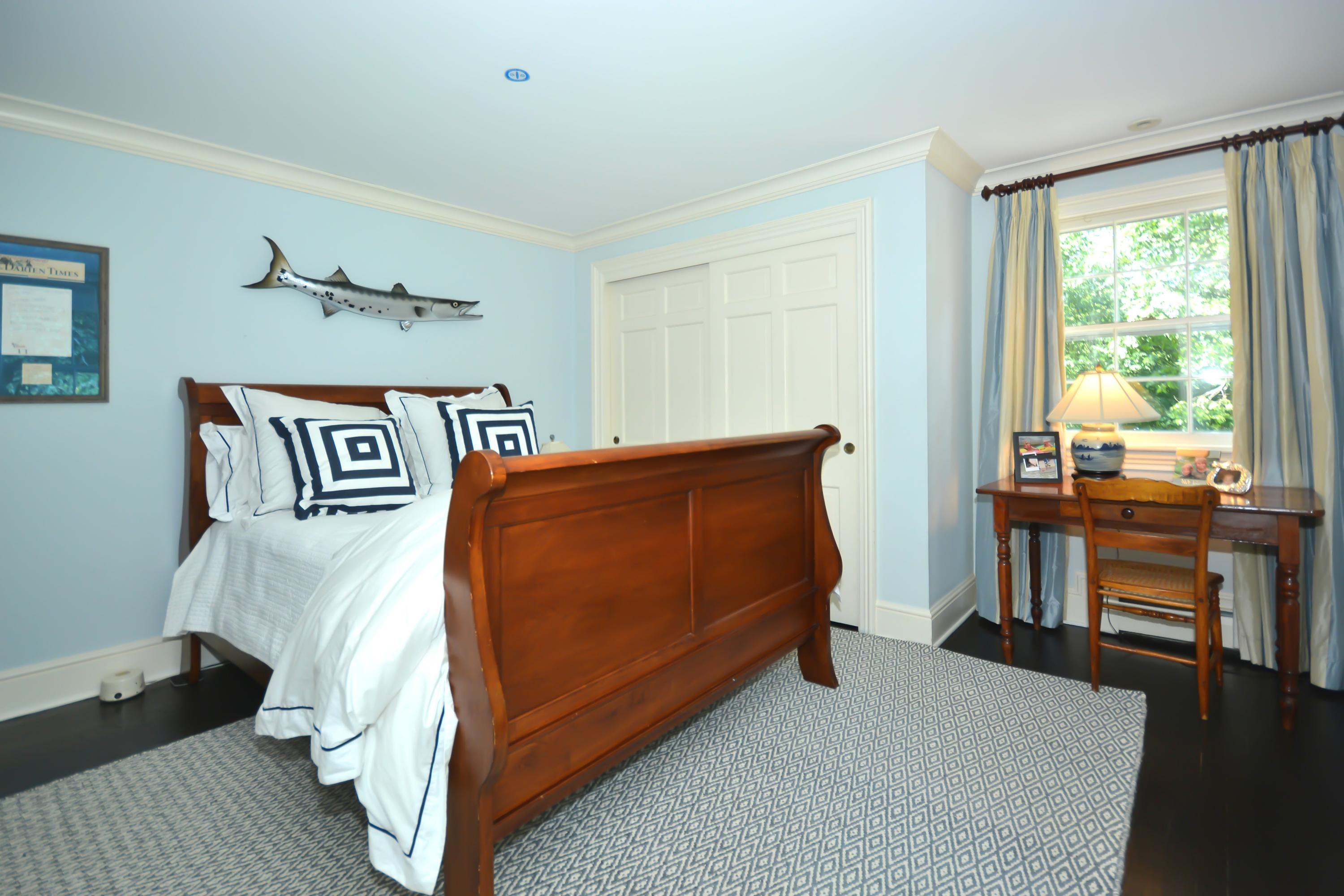 47 Delafield Island Road Darien, CT 06820 - Photo 18 of 26 a bedroom with a bed and a window