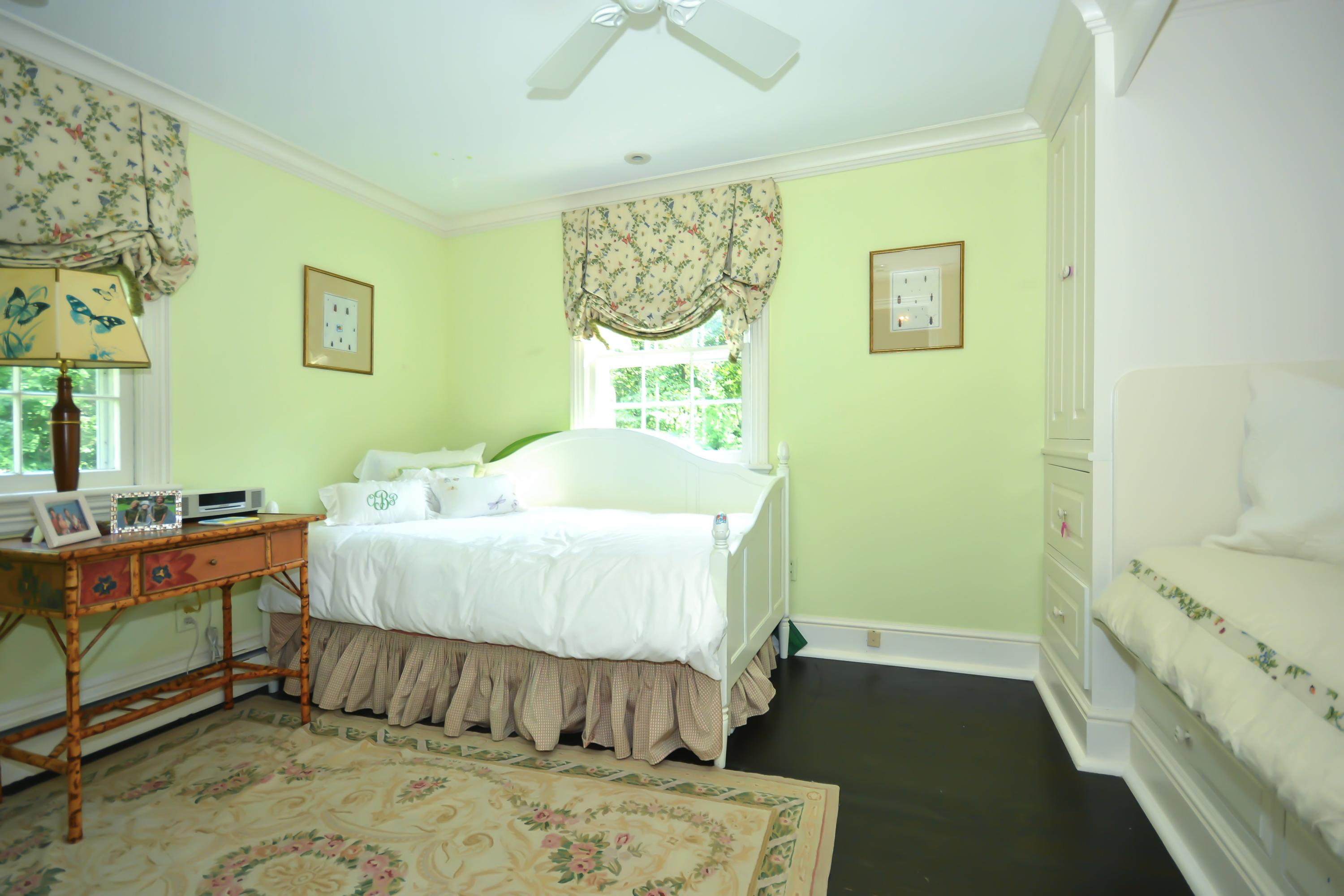 47 Delafield Island Road Darien, CT 06820 - Photo 22 of 26 a bed sitting in a bedroom next to a window