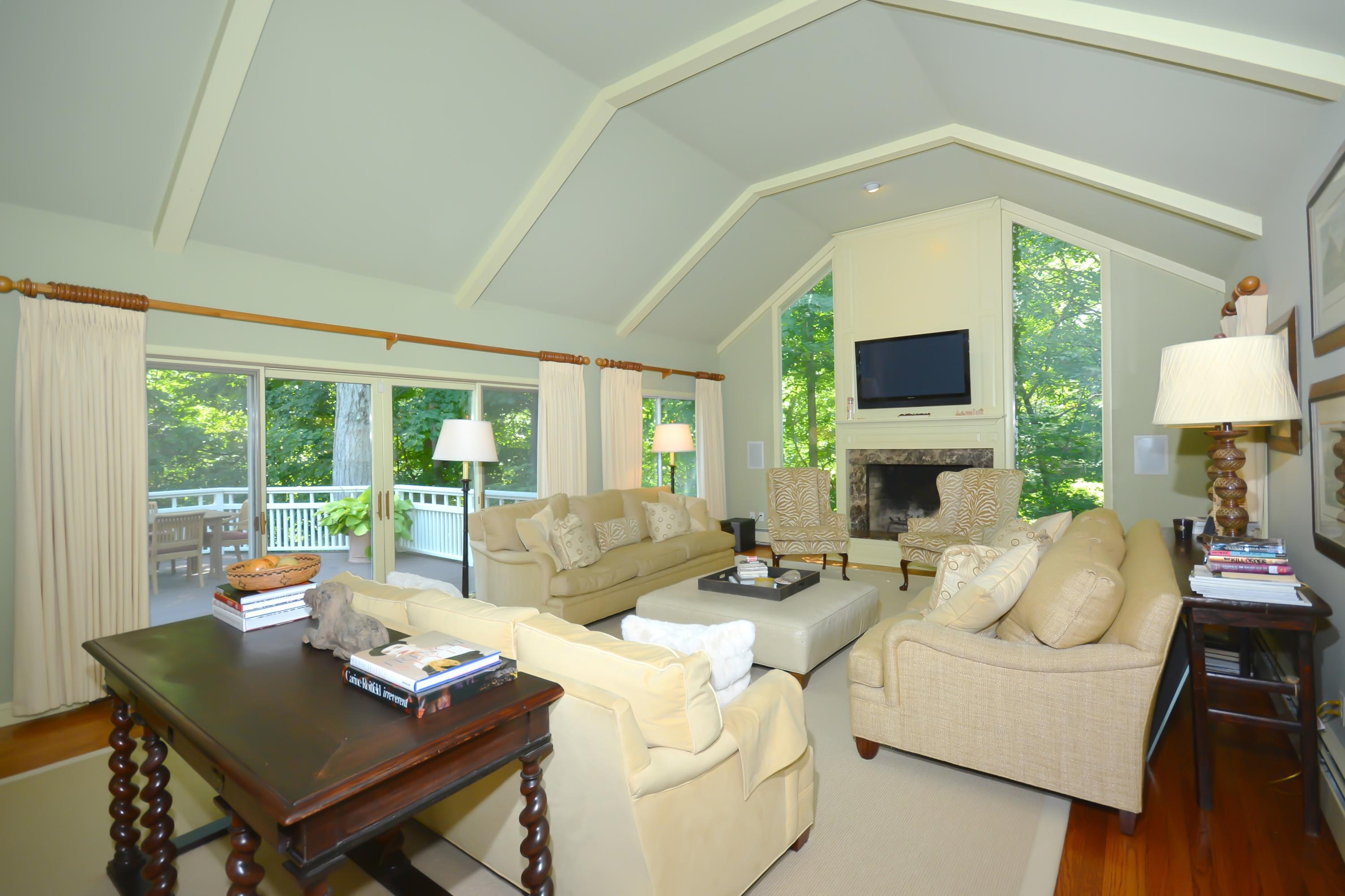 47 Delafield Island Road Darien, CT 06820 - Photo 6 of 26 a living room with furniture a fireplace and a flat screen tv