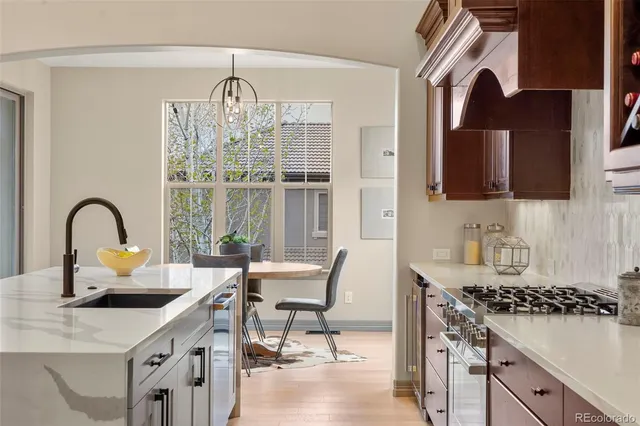 a kitchen with a table chairs and a stove