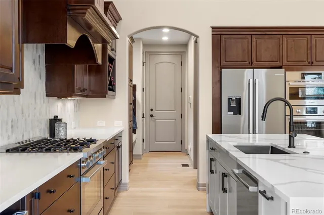 a kitchen with a sink cabinets and stainless steel appliances