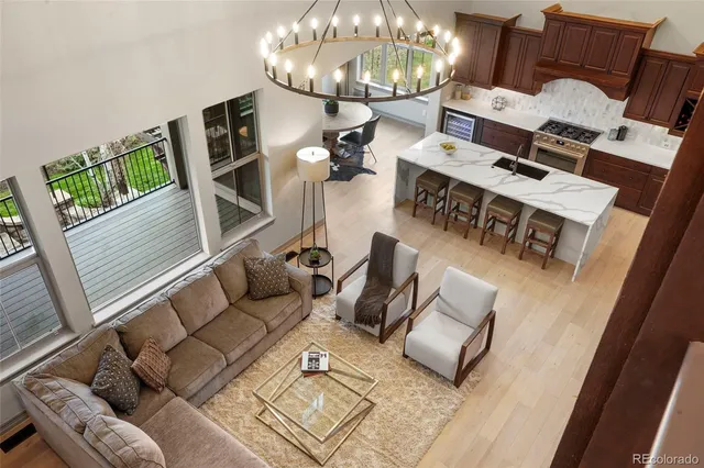 a living room with furniture and a chandelier