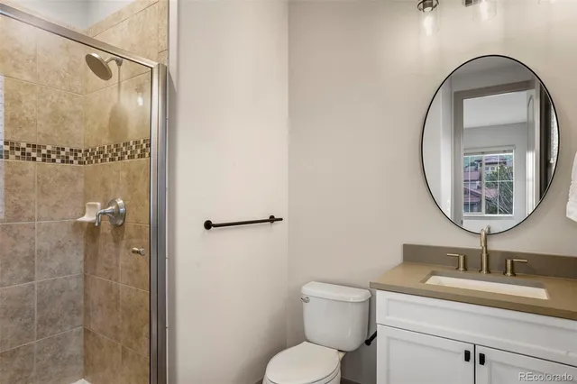 a bathroom with a toilet a sink and a mirror