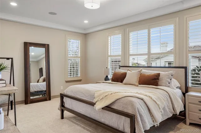 a bedroom with a bed and a large window