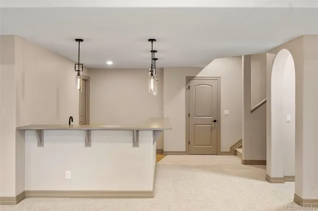 a view of a kitchen with a refrigerator and a sink
