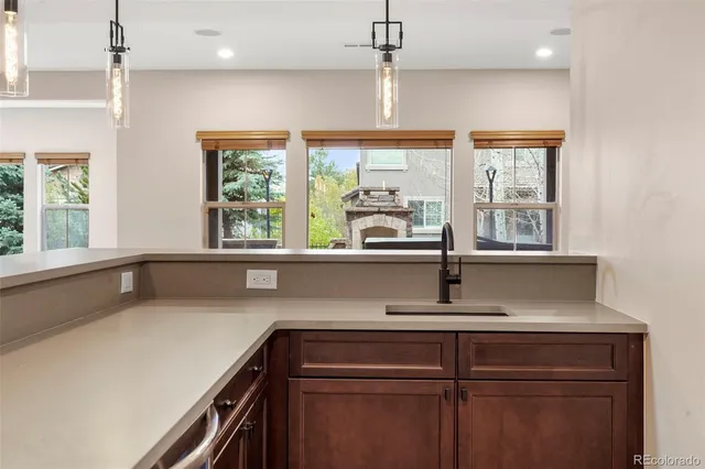 a view of a kitchen with a sink and windows
