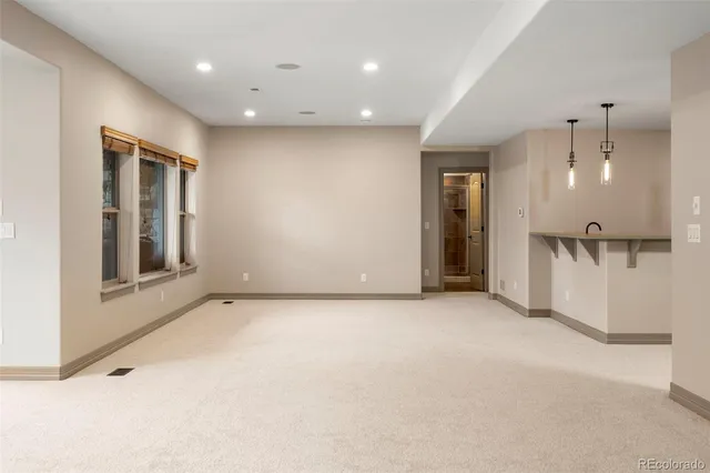 an empty room with a cabinet and a window