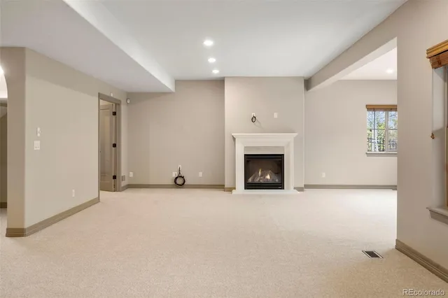 a view of an empty room with a fireplace