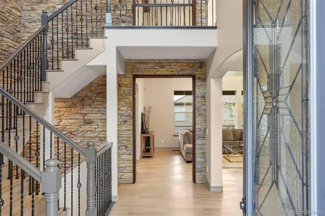 a view of entryway and hall with wooden floor