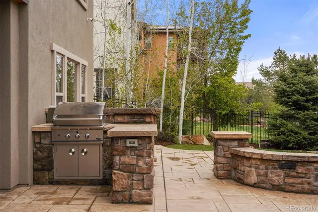 a view of a patio with table and chairs