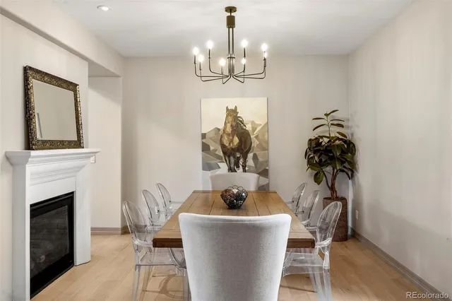 a living room with furniture a chandelier and a fireplace