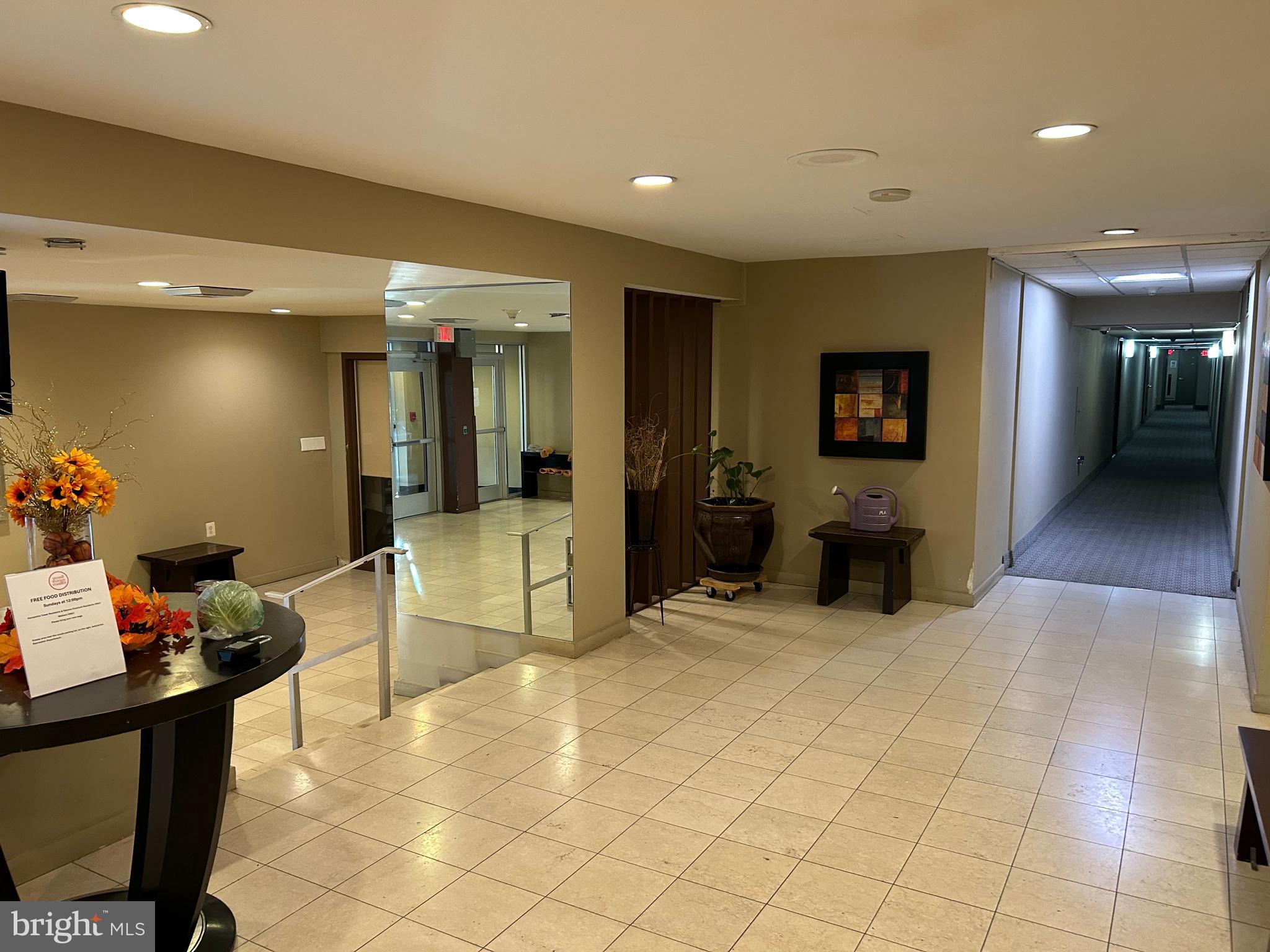 7333 New Hampshire Avenue, Unit 1107 Takoma Park, MD 20912 - Photo 7 of 25 a lobby with furniture and a potted plant