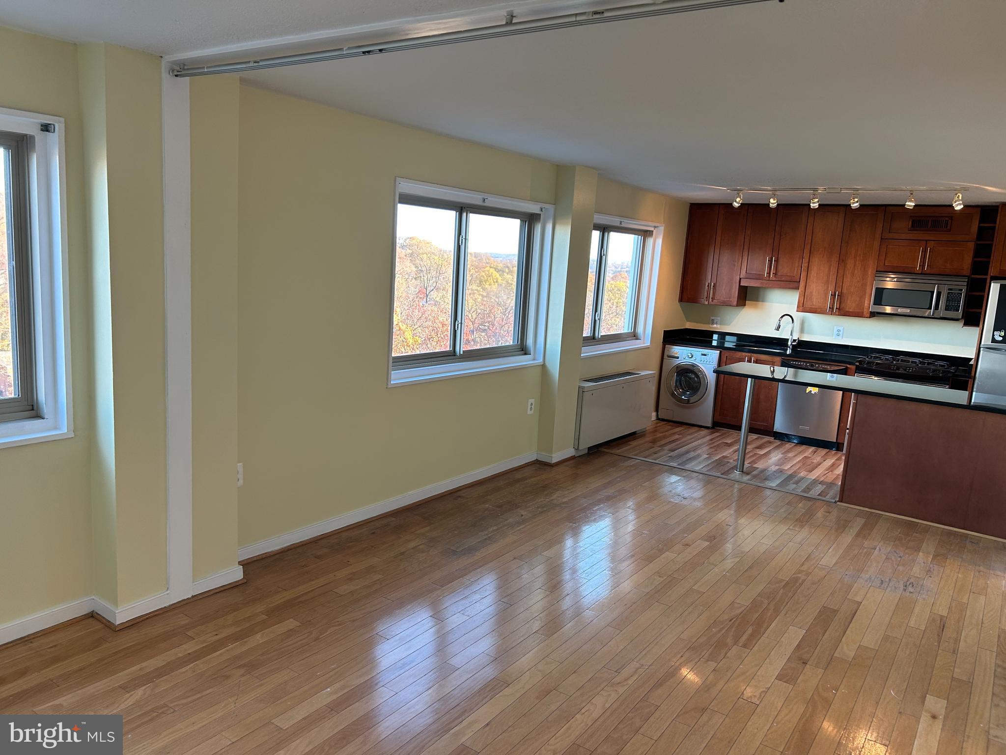 7333 New Hampshire Avenue, Unit 1107 Takoma Park, MD 20912 - Photo 10 of 25 a kitchen with stainless steel appliances granite countertop a stove a sink and a refrigerator