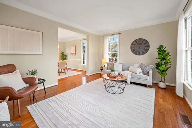 a view of a patio with chairs and floor to ceiling window with wooden floor