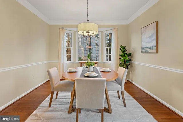 a front view of a house with a garden and trees