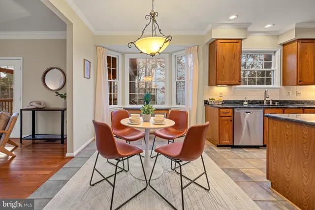 a view of a patio with couches table and chairs and potted plants