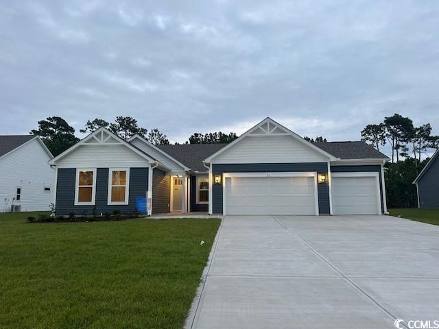 85 Northbrook Drive Murrells Inlet, SC 29576 - Photo 1 of 34 View of front facade with concrete driveway, an attached garage, and a front yard