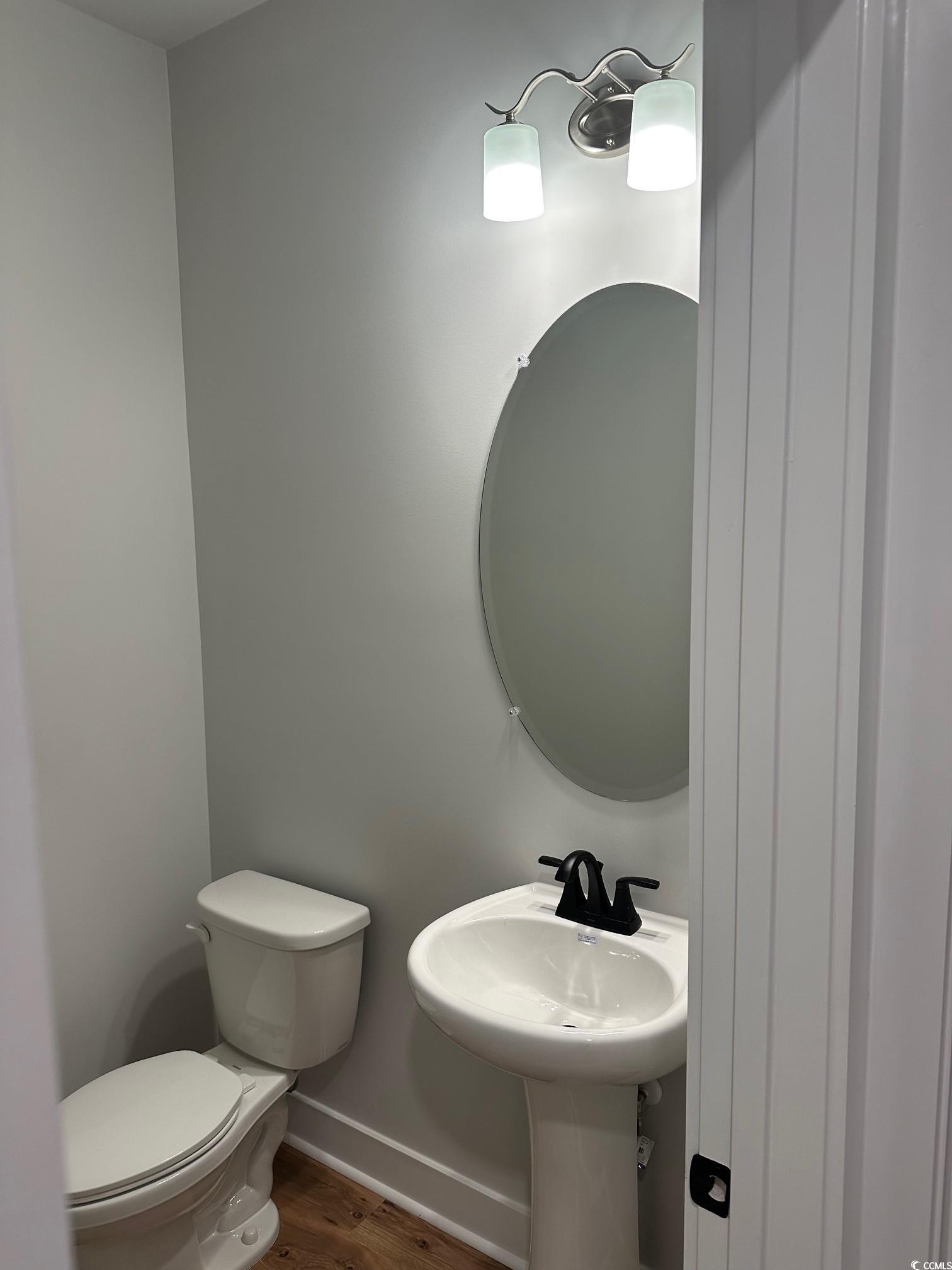 85 Northbrook Drive Murrells Inlet, SC 29576 - Photo 19 of 34 Half bathroom featuring wood finished floors and toilet