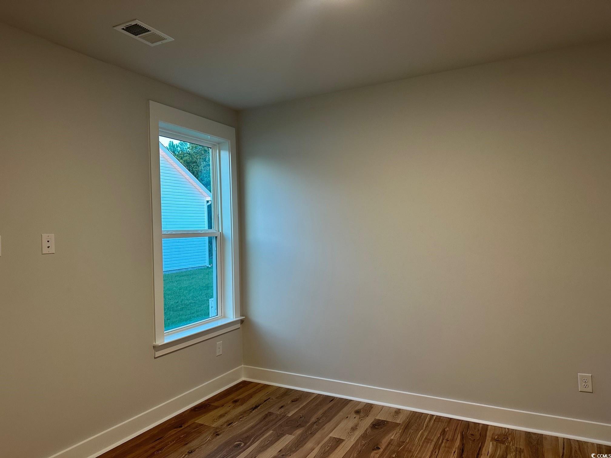 85 Northbrook Drive Murrells Inlet, SC 29576 - Photo 22 of 34 Empty room with baseboards and dark wood finished floors