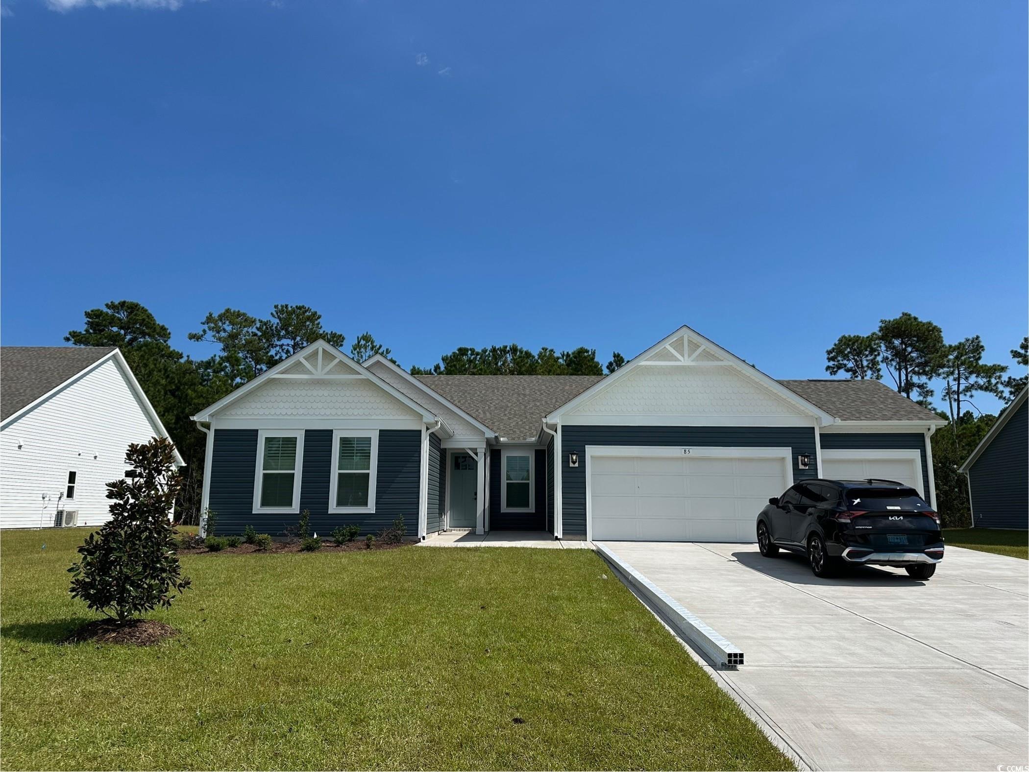 85 Northbrook Drive Murrells Inlet, SC 29576 - Photo 3 of 34 View of front of home featuring concrete driveway, a front yard, and an attached garage