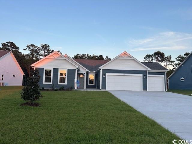 85 Northbrook Drive Murrells Inlet, SC 29576 - Photo 33 of 34 Ranch-style house featuring driveway, a garage, and a front yard