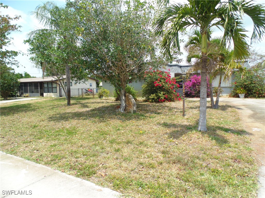 18215 Iris Road Fort Myers, FL 33967 - Photo 2 of 34 a backyard of a house with table and chairs