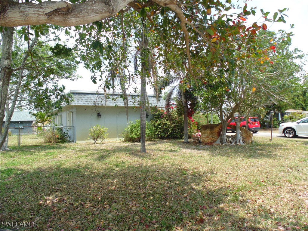 18215 Iris Road Fort Myers, FL 33967 - Photo 3 of 34 a house with trees in front of it