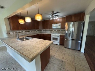 18215 Iris Road Fort Myers, FL 33967 - Photo 5 of 34 a kitchen with stainless steel appliances granite countertop a sink a stove and a refrigerator