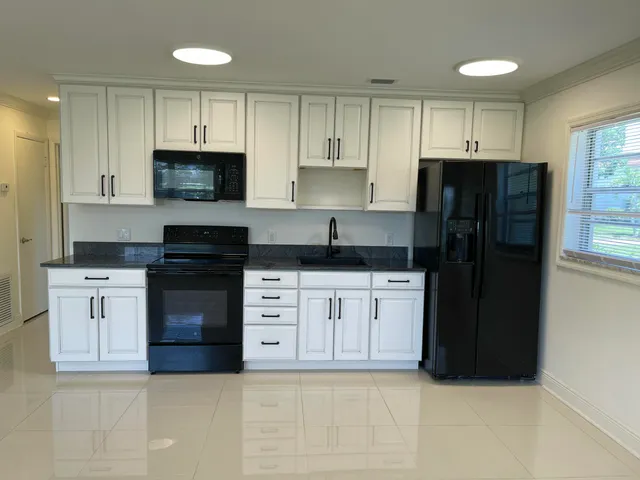 a kitchen with a refrigerator stove and microwave