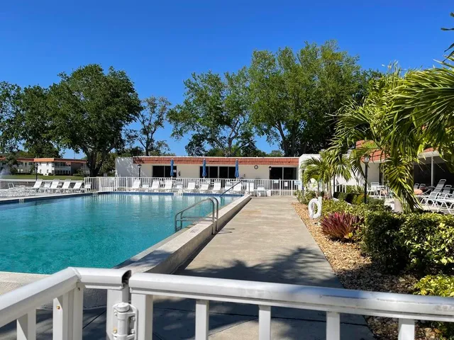 a view of a swimming pool and lounge chairs