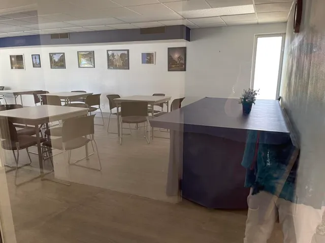 a view of a dining room with furniture and window