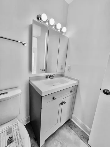 a bathroom with a sink toilet and mirror