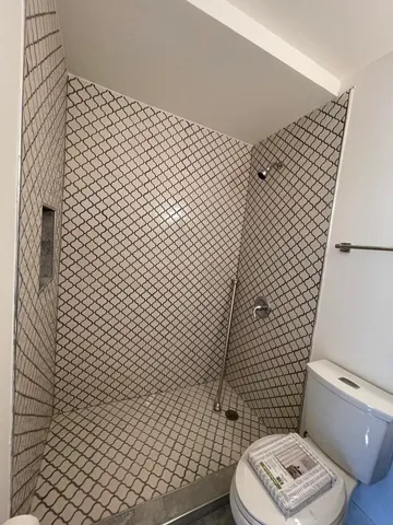 an empty room with a ceiling fan and a window