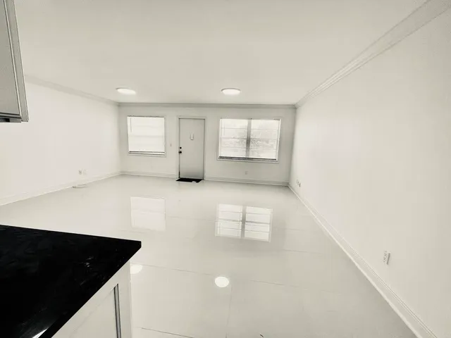 a view of kitchen with cabinets and wooden floor