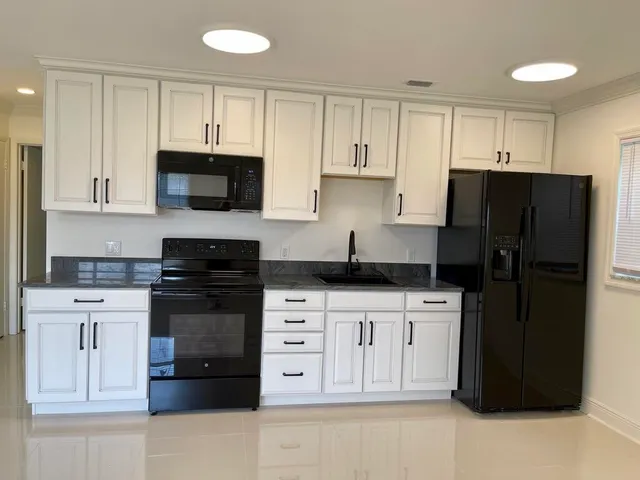 a view of kitchen with kitchen island and stainless steel appliances