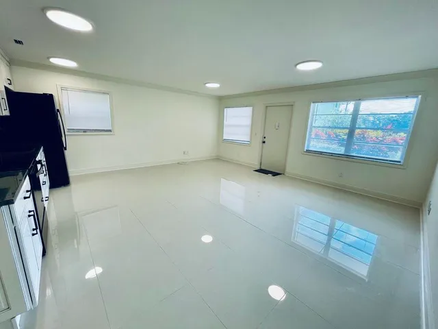 a kitchen with stainless steel appliances granite countertop a stove microwave and cabinets