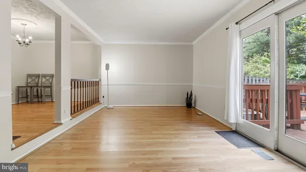 a bedroom with a large bed and a chandelier fan