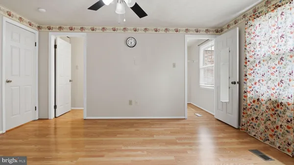 a view of a hallway with wooden floor