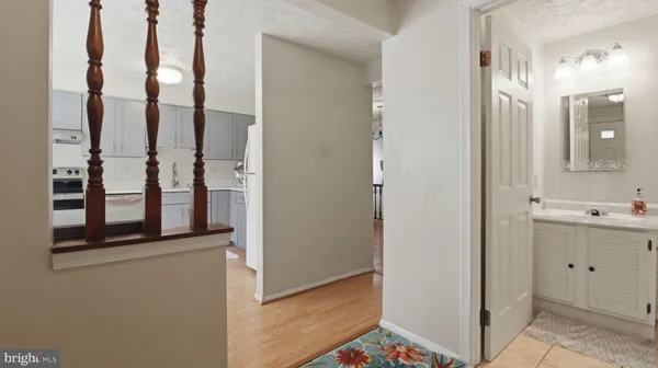 a kitchen with a refrigerator sink and cabinets