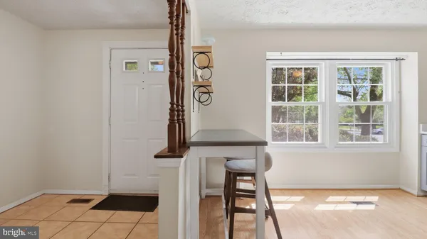 a view of a kitchen with furniture and wooden floor