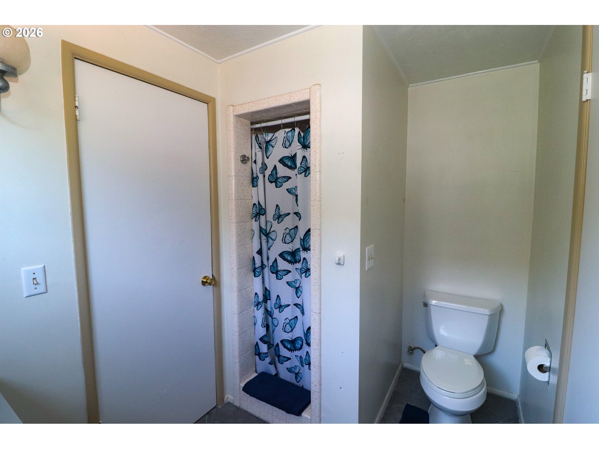 7077 Main Street Springfield, OR 97478 - Photo 24 of 34 a bathroom with a toilet and a shower