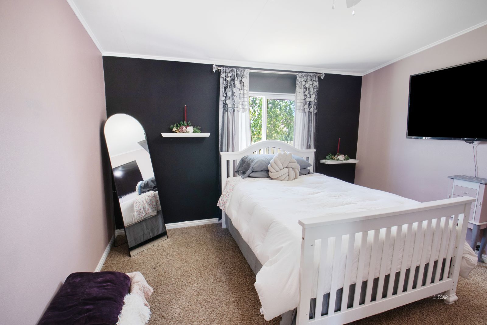 591 Spring Valley Parkway Spring Creek, NV 89815 - Photo 18 of 25 a bedroom with a bed and a television