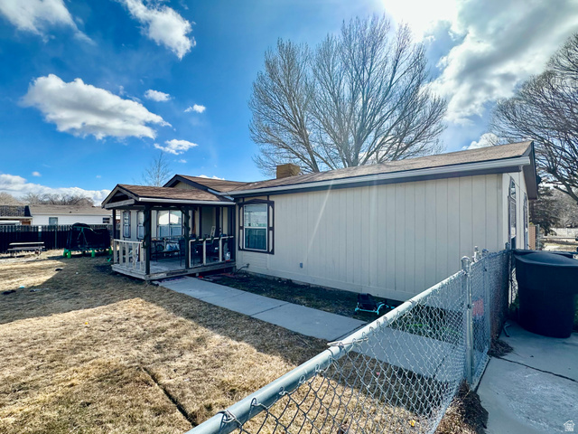 2180 North 1950th Street West Helper, UT 84526 - Photo 1 of 11 Rear view of property with a chimney and a shingled roof