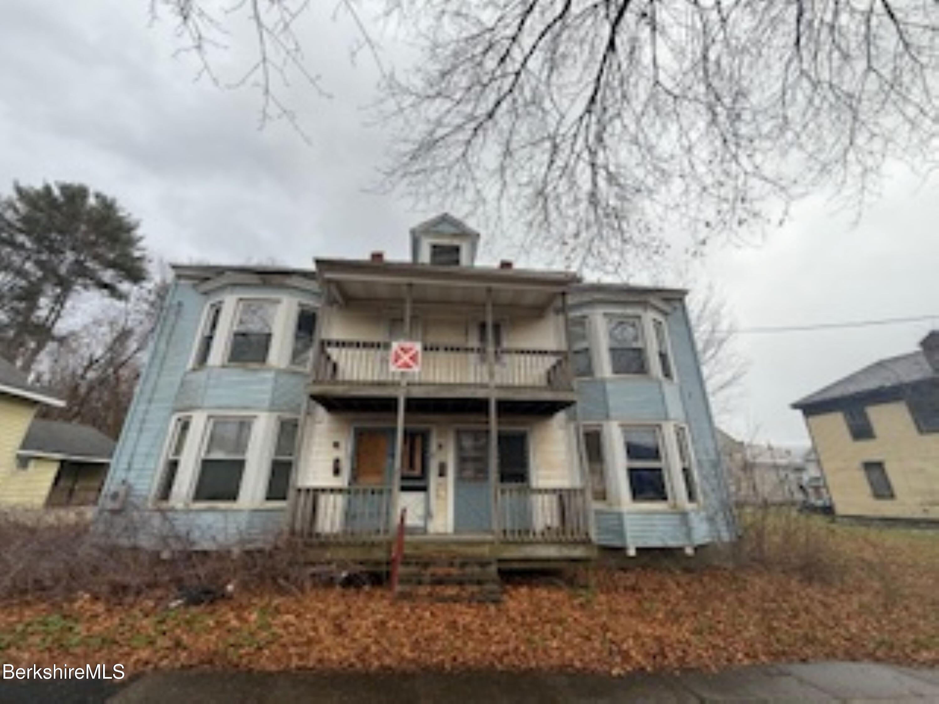 32-38 Spring Street North Adams, MA 01247 - Photo 1 of 32 a front view of a residential apartment building with a yard