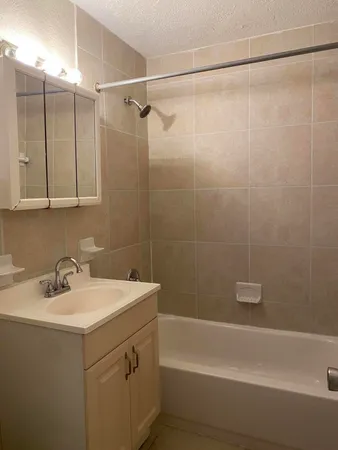 a bathroom with a sink a mirror and a shower