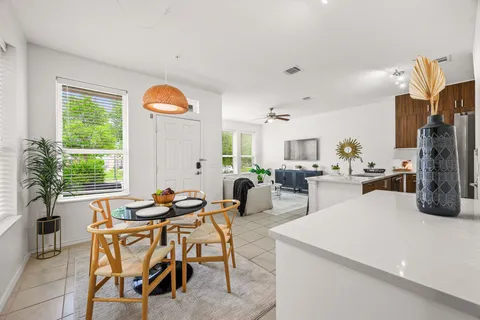 a view of kitchen with stainless steel appliances granite countertop sink stove and white cabinets