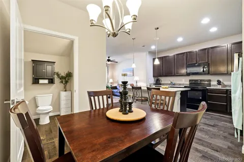 a kitchen with stainless steel appliances a dining table and chairs