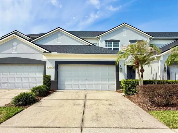 a front view of a house with a yard and garage