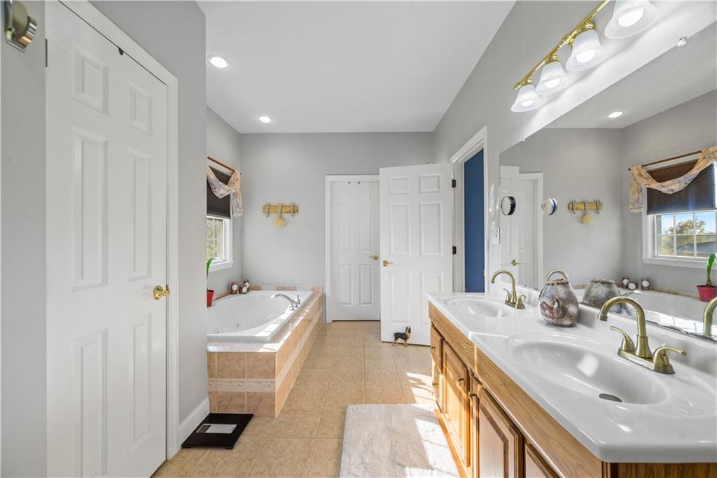 747 Achortown Road Beaver Falls, PA 15010 - Photo 15 of 28 a bathroom with a sink a toilet a shower and a mirror