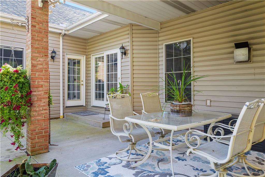 747 Achortown Road Beaver Falls, PA 15010 - Photo 23 of 28 a view of a patio with table and chairs and potted plants
